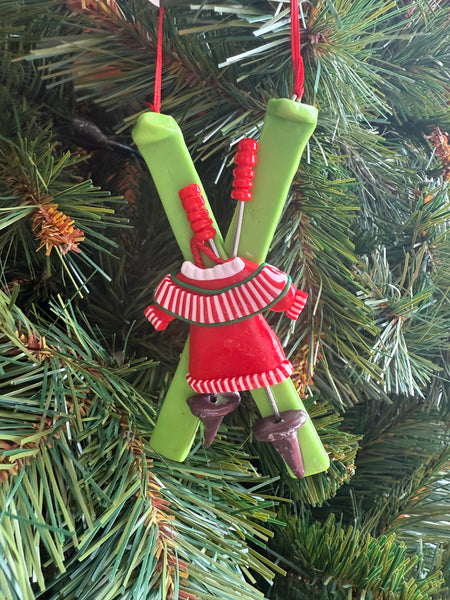 Green skis with red jumper